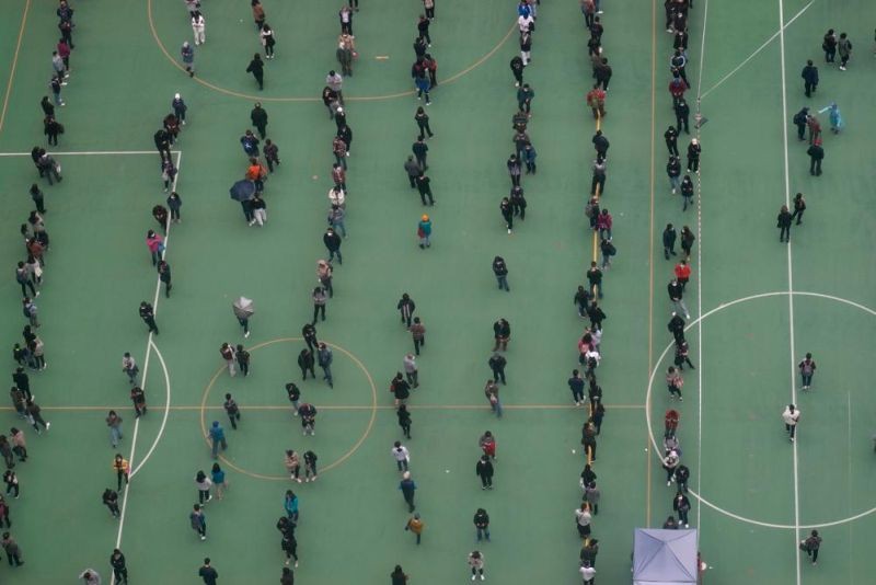 Residents line up to get tested for the coronavirus at a temporary testing center for COVID-19 in Hong Kong, Thursday, Feb. 10, 2022. (AP Photo)