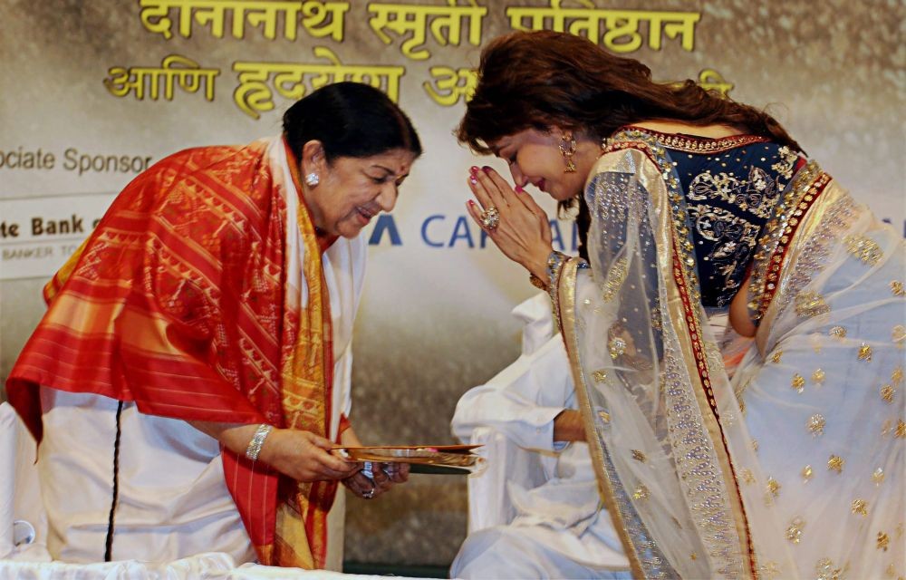 Mumbai: In this file image dated, Tuesday, April 25, 2012, actress Madhuri Dixit greets legendary singer Lata Mangeshkar while receiving Deenanath Mangeshkar award from her at a function in Mumbai. The legendary singer passed away Sunday morning, Feb 6, 2022 at Mumbai's Breach Candy Hospital at the age of 92. (PTI Photo)