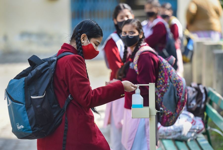 New Delhi: Students sanitise their hands before entering the premises, after schools reopened following ease in COVID-induced restrictions, in New Delhi, Monday, Feb. 7, 2022. (PTI Photo/Atul Yadav)