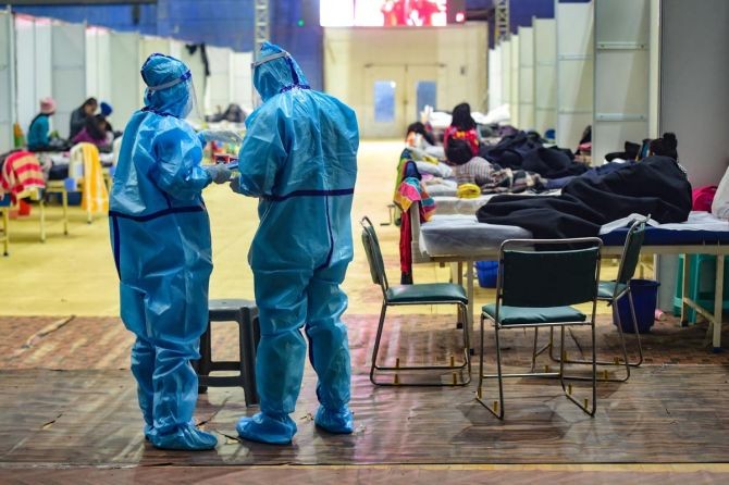 Medics prepare to give medicines to infected children at the covid care centre at the Commonwealth games village in New Delhi, January 11, 2022. Photograph: Kamal Kishore/PTI Photo