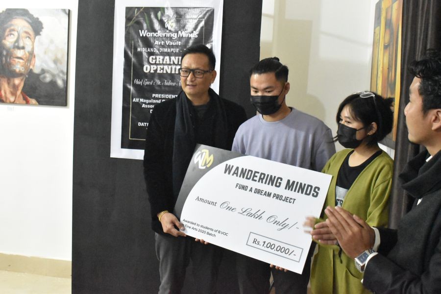 Dr Andrew Ahoto Sema, President ANPSA, Dimapur presenting the cheque offered by the Wandering Minds for the students of B.Voc. in Fine Arts.