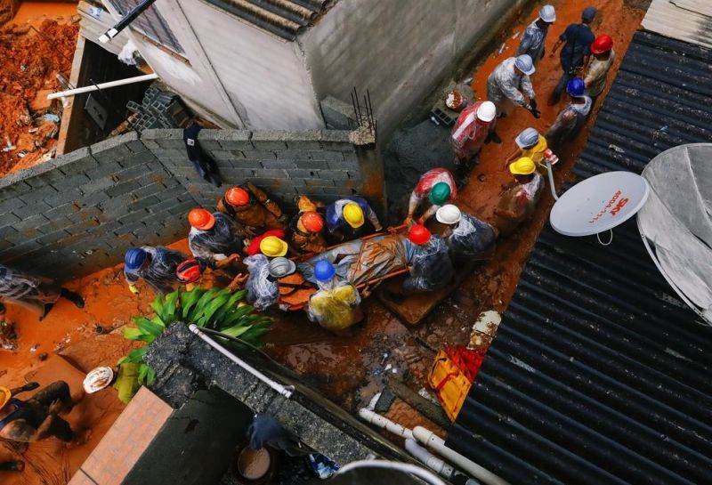 Firefighters remove the body of a landslide victim after heavy rains in Franco da Rocha, Sao Paulo state, Brazil, Monday, Jan 31, 2022. At least 19 people have died in cities in the interior of Brazil's largest state, Sao Paulo, after landslides caused by heavy rains that have hit the region since Saturday. (AP Photo)