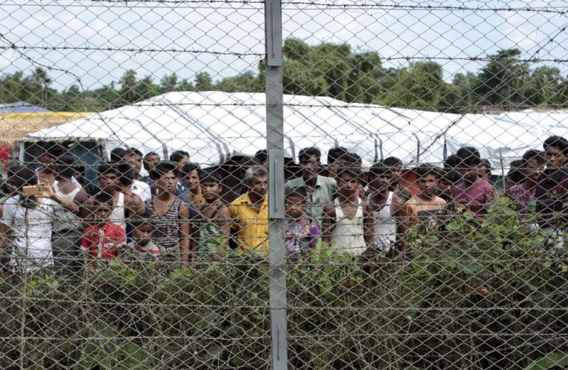 Rohingya refugees gather near a fence during a government organized media tour, to a no-man's land between Myanmar and Bangladesh, near Taungpyolatyar village, Maung Daw, northern Rakhine State, Myanmar, June 29, 2018. An international case accusing Myanmar of genocide against the Rohingya ethnic minority returns to the United Nations' highest court Monday, Feb. 21, 2022, amid questions over whether the country's military rulers should even be allowed to represent the Southeast Asian nation. (AP File Photo)