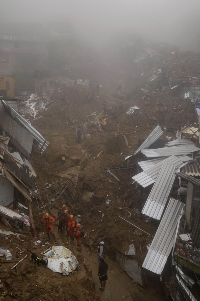Rescue workers use a search dog to look for survivors after mudslides in Petropolis, Brazil on February 16, 2022. Extremely heavy rains set off mudslides and floods in a mountainous region of Rio de Janeiro state, killing multiple people, authorities reported. (AP/PTI Photo)