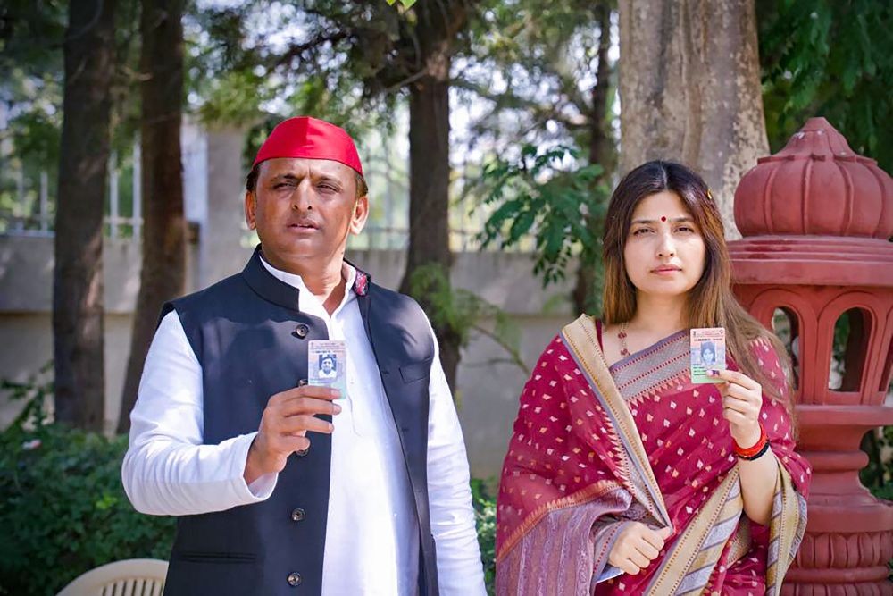 ON SUNDAY, FEB. 20, 2022.** Saifai: Samajwadi Party President Akhilesh Yadav with his wife and former MP Dimple Yadav pose for photos holding their identification cards, during the third phase of UP Assembly elections, in Saifai. (PTI Photo)
