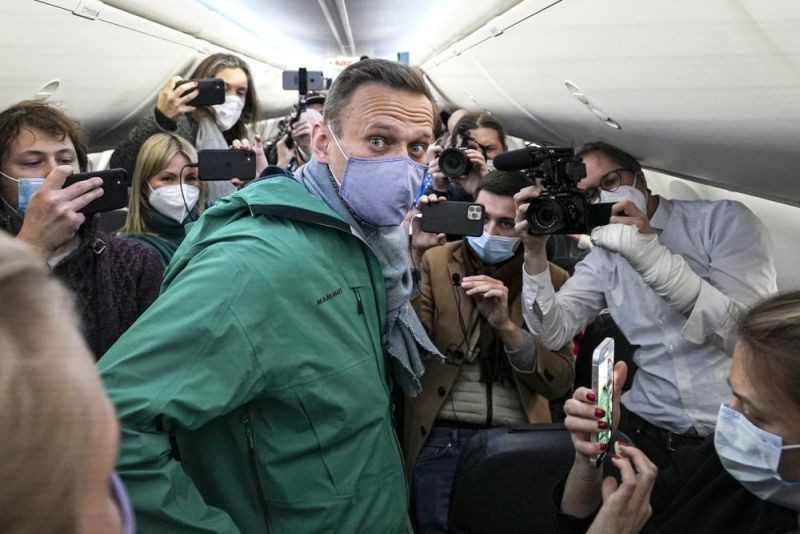 Alexei Navalny is surrounded by journalists in a plane before a flight to Moscow in the Berlin Brandenburg Airport on Sunday, Jan. 17, 2021. The prison sentence imposed on the leading Kremlin critic was a severe blow to Russia's opposition — and then the situation got worse. Over the past 12 months, scores of activists, independent journalists and rights advocates have been targeted with raids, detained and designated as terrorists and foreign agents. (AP File Photo)