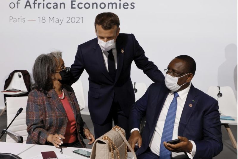French President Emmanuel Macron, center, salutes Ethiopia's President Sahle-Work Zewde, left, and Senegal's President Macky Sall at the Summit on the Financing of African Economies on May 18, 2021 in Paris. European Union leaders want to re-engage with African nations and counter the growing influence from China and Russia across the continent during a two-day summit in Brussels.The EU-African Union gathering starting Thursday, Feb. 17, 2022, was initially planned for 2020 but was postponed due to the coronavirus pandemic and agenda issues. So it's the first time EU and African Union leaders meet in that format since 2017. (AP File Photo