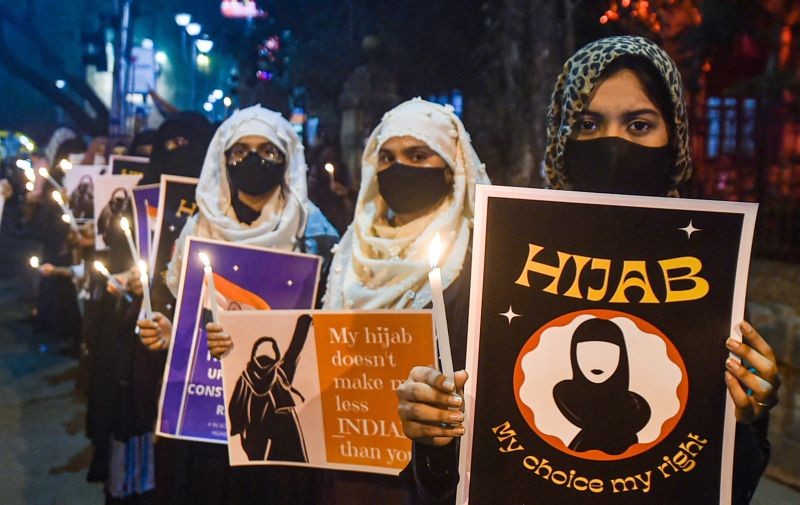 Muslim women wearing protective face masks participate in a candle light march during a protest rally over the 'hijab' controversy of Karnataka, in Kolkata on February 11, 2022. (PTI Photo)