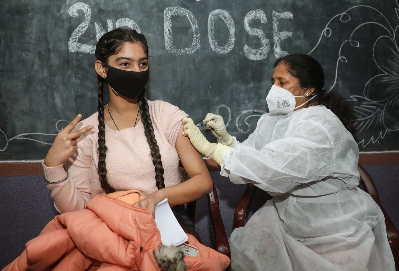 A health worker administers COVID-19 vaccine to a teenage beneficiary, in Jammu on February 1, 2022. (PTI Photo)