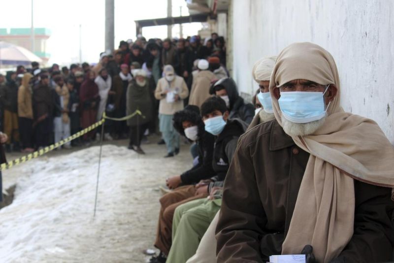 Afghans wait to receive food rations organized by the World Food Program (WFP) in Pul-e-Alam, the capital of Logar province, eastern of Afghanistan, Tuesday, Jan. 18, 2022. The Taliban's sweep to power in Afghanistan in August drove billions of dollars in international assistance out of the country and sent an already dirt-poor poor nation, ravaged by war, drought and floods, spiralling toward a humanitarian catastrophe. (AP File Photo)