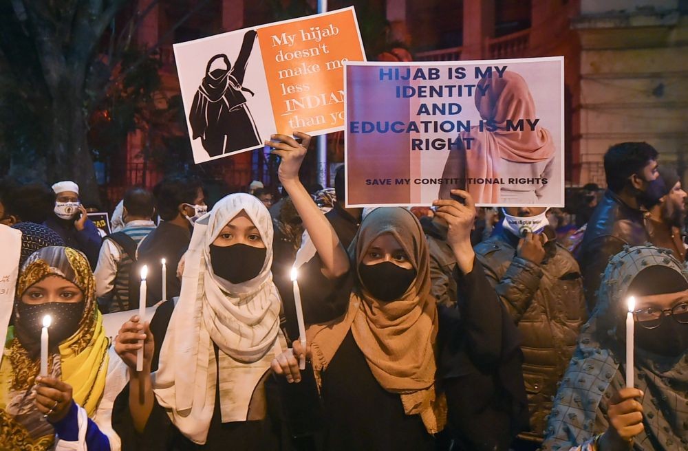 Kolkata: Muslim women holding candles and placards, participate in a candlelight march in protest over the 'hijab' controversy in Karnataka, in Kolkata, Friday, Feb. 11, 2022. (PTI Photo/Swapan Mahapatra)