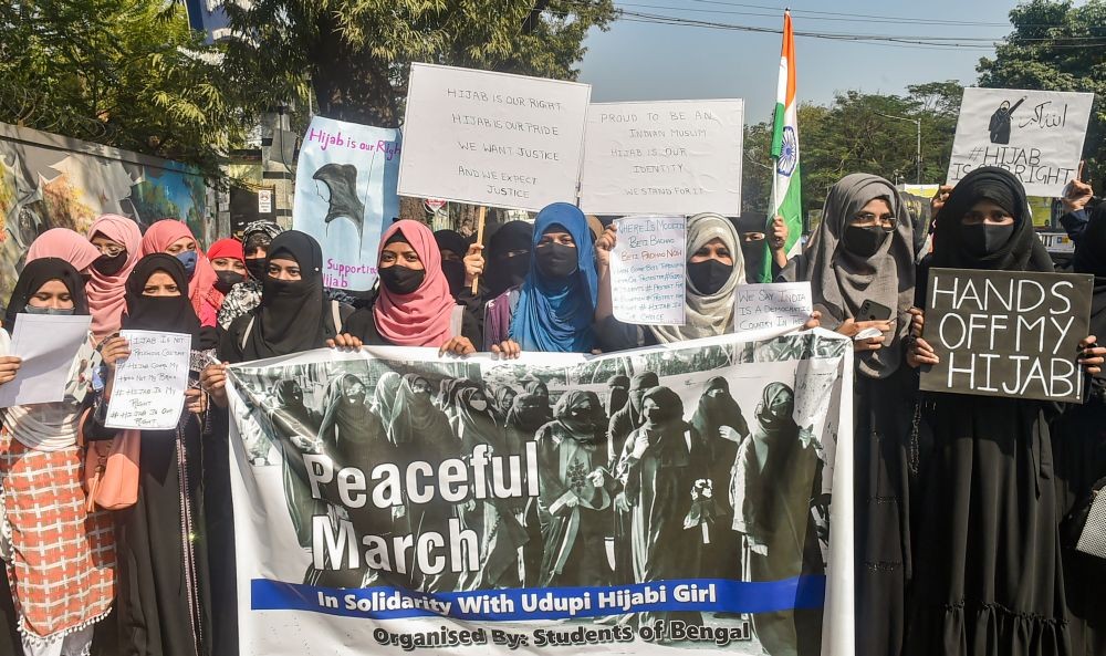 Kolkata: Muslim women hold placards while wearing burqa and hijab in a protest march, in support of female Muslim students, in Kolkata, Saturday, Feb. 12, 2022. Female Muslim students were allegedly barred from attending classes while wearing hijab in various educational institutes in Karnataka. (PTI Photo/Swapan Mahapatra)