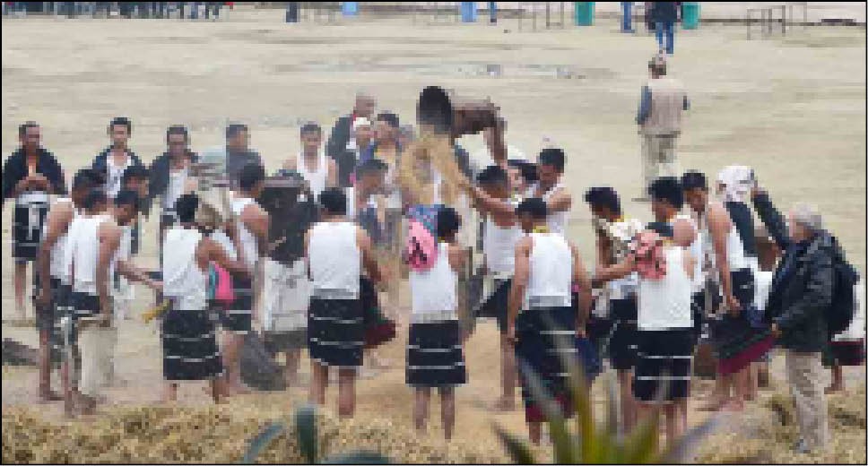 A cultural troupe demonstrating the rice paddy harvesting during the Sekrenyi Mini Hornbill Festival held at Khuochiezie Ground, Kohima on February 25. (Morung Photo)