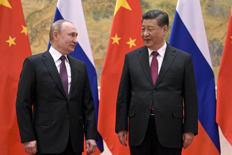 Chinese President Xi Jinping, right, and Russian President Vladimir Putin talk to each other during their meeting in Beijing, Friday, Feb. 4, 2022. Following this month’s meeting in Beijing between Russian leader Vladimir Putin and China’s Xi Jinping, speculation has risen over whether a new alliance could form between the two superpowers locked in competition with the U.S. (AP File Photo )