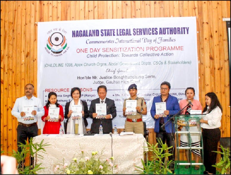Gauhati High Court Judge Justice Songkhupchung Serto, NSLSA Member Secretary Mezivolu T Therieh, NJS and resource persons releasing the Mega Legal Camps magazine. (Morung Photo)