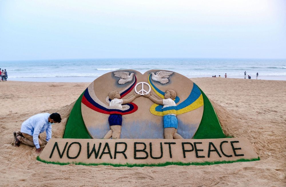 Puri: Sand artist Sudarsan Pattnaik creates a sculpture dedicated to peace with the message 'No War But Peace', amid the ongoing Ukraine crisis, in Puri, Tuesday, Feb. 22, 2022. (PTI Photo)
