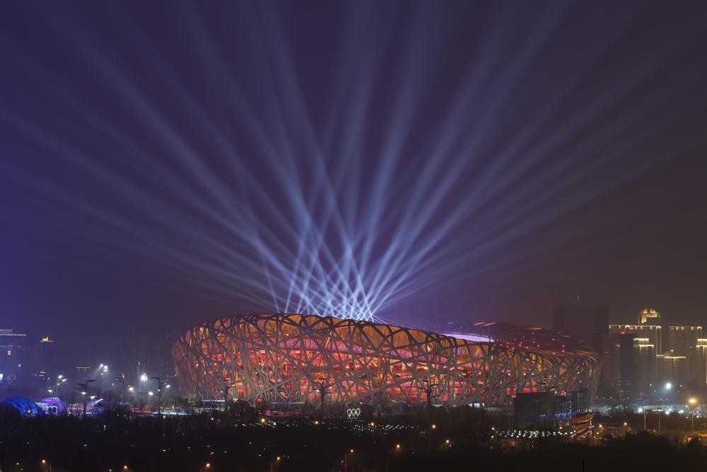 FILE - Lights shine during a rehearsal for the opening ceremony of the 2022 Winter Olympics at the National Stadium, known as the Bird's Nest in Beijing, China, Jan. 30, 2022. The artist Ai Weiwei helped design the stadium for the 2008 Olympics. It's again the venue for the opening ceremony of the 2022 Beijing Winter Olympics. (AP Photo/Wang Xinchao, File)