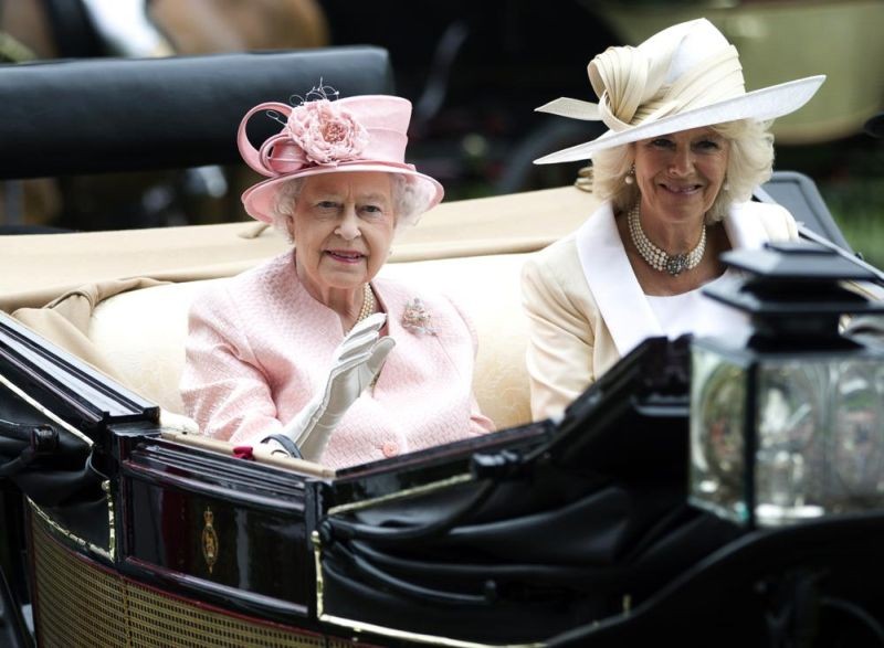 Britain s Queen Elizabeth II waves to the crowds with Camilla, Duchess of Cornwall at right, as they arrive by carriage on the first day of the Royal Ascot horse race meeting in Ascot, England, Tuesday, June 18, 2013. Queen Elizabeth II has offered her support to have the Duchess of Cornwall become Queen Camilla — using a special Platinum Jubilee message to make a significant decision in shaping the future of the monarchy. (AP File Photo)