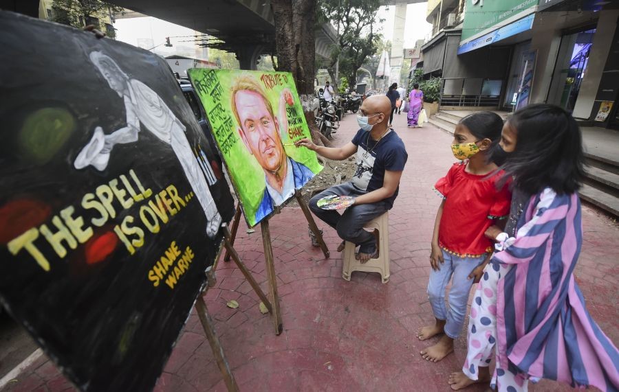 Mumbai: An Indian artist Sagar Kambli makes a painting of Australian cricketer Shane Warne as a mark of tribute to the cricketer, on a sidewalk in Mumbai, Saturday, March 5, 2022. Warne passed away due to a suspected heart attack at the age of 52, on Friday. (PTI Photo/Shashank Parade)