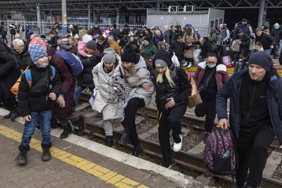 People, mostly women and children, try to get onto a train bound for Lviv, at the Kyiv railway station, Ukraine on March 4, 2022. Russia's war on Ukraine is now in its ninth day and Russian forces have shelled Europe's largest nuclear power plant, sparking a fire there that was extinguished overnight. (AP/PTI Photo)