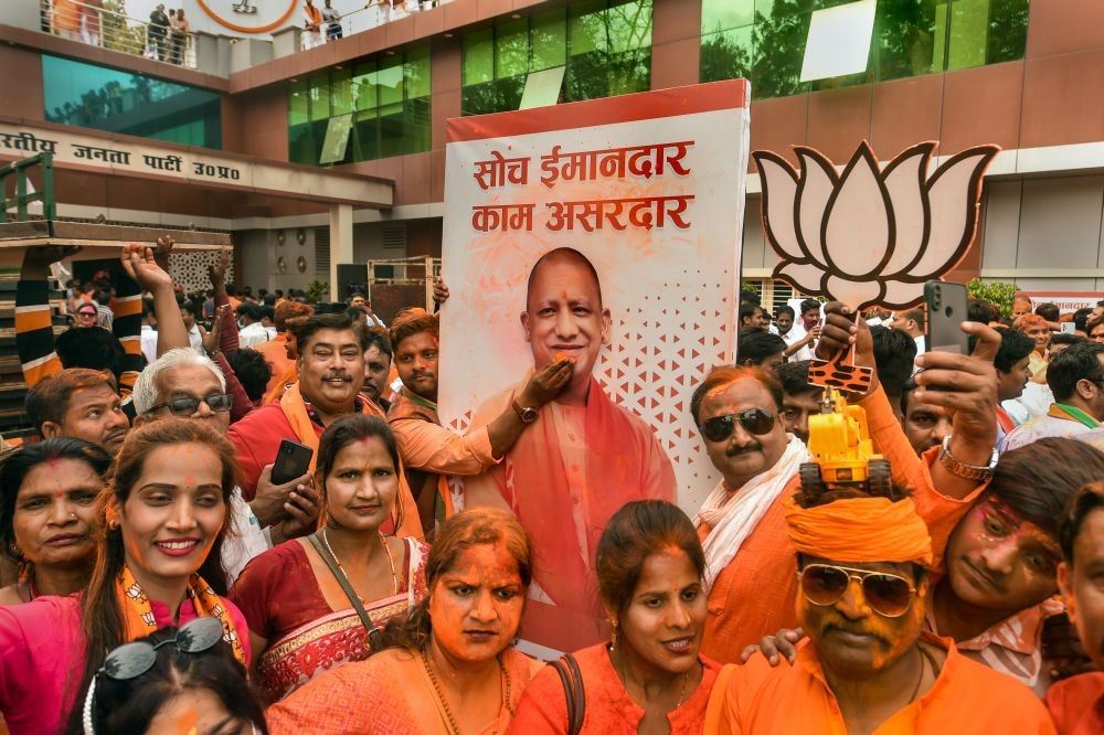 Lucknow: BJP supporters celebrate with colours, as the party heads to a landslide victory, in UP Assembly elections, at the party office, in Lucknow, Thursday, March 10, 2022. (PTI Photo/Nand Kumar) .