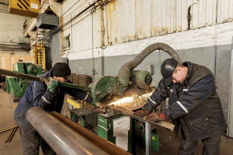 Two workers weld metal inside the Interpipe Steel plant in Dnipro, Ukraine on March 10, 2022. (AP File Photo)