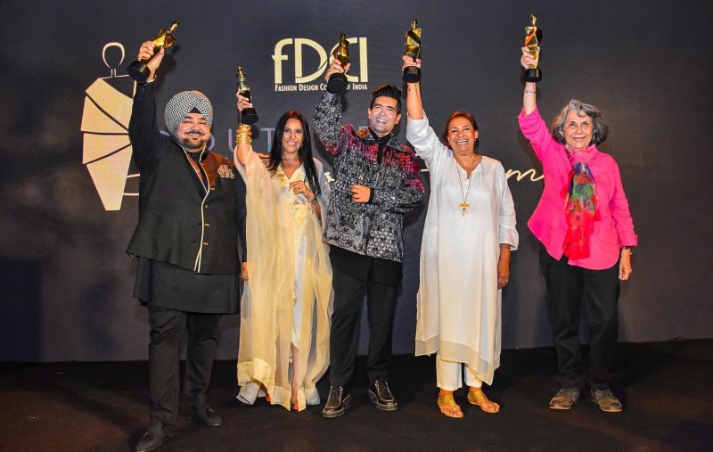 (L-R) Fashion designers JJ Valaya, Anamika Khanna, Manish Malhotra, Vidyun Singh and Asha Kochhar pose for photos after being honoured by the FDCI during the second edition of the FDCI Couture Hall of Fame Awards, in New Delhi, Wednesday night, March 30, 2022. (PTI Photo)