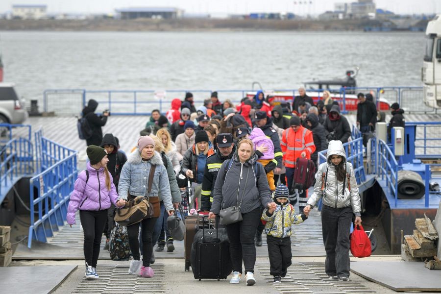 Isaccea : Refugees fleeing the war from neighbouring Ukraine walk after crossing the border by ferry at the Isaccea-Orlivka border crossing, in Romania, Friday, March 25, 2022. AP/PTI