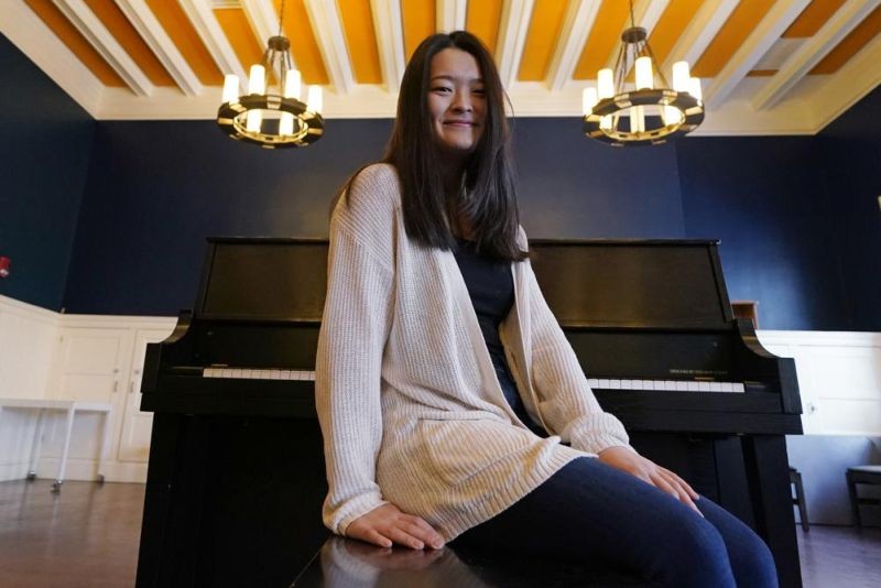 Julia Riew poses at Farkus Hall, on the campus of Harvard University in Cambridge, Mass on February 16, 2022. (AP File Photo)