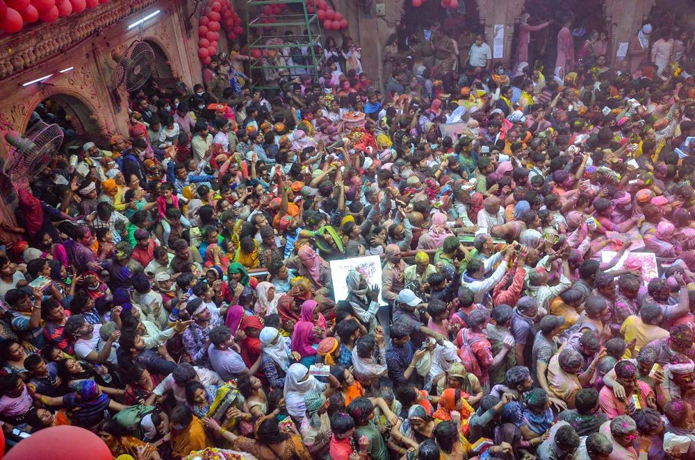 Mathura: Devotees celebrate Holi at Bankey Bihari Temple in Vrindavan, Mathura district, Monday, March 14, 2022. (PTI Photo)