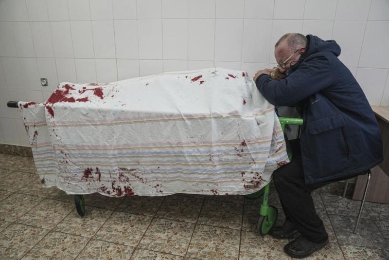 Serhii, father of teenager Iliya, cries on his son's lifeless body lying on a stretcher at a maternity hospital converted into a medical ward during the war with Russia in Mariupol, Ukraine on March 2, 2022. (AP File  Photo)