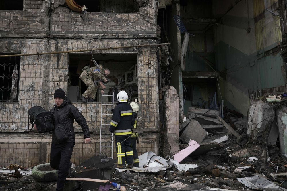 Kyiv: Ukrainian firefighters and soldiers search in an apartment building after it was hit by artillery shelling in Kyiv, Ukraine, Monday, March 14, 2022. AP/PTI