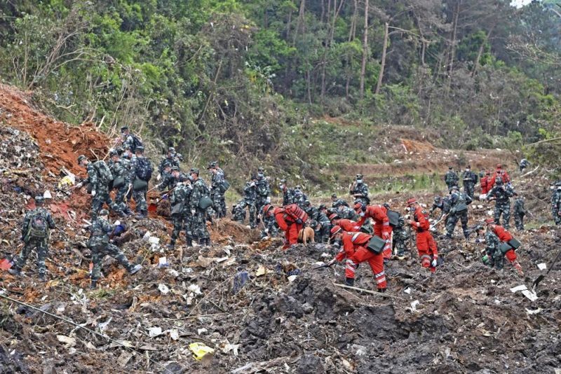 In this photo released by Xinhua News Agency, rescue workers search for the black boxes at a plane crash site in Tengxian county, southwestern China's Guangxi Zhuang Autonomous Region, Tuesday, March 22, 2022. (AP Photo)