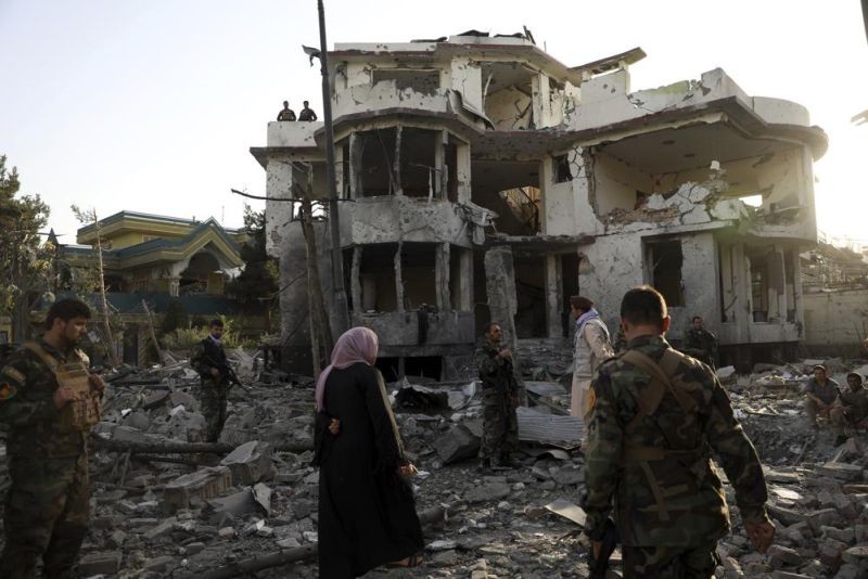 Afghan security personnel inspect a damaged building in the aftermath of an attack in Kabul, Afghanistan, on Aug. 4, 2021. The U.N.'s aid coordination office on Thursday, March 31, 2022, is launching its biggest-ever appeal for funds for a single country in hopes of collecting $4.4 billion to help Afghanistan, a decidedly ambitious call made when much of the world’s attention is on Russia's war in Ukraine. (AP File Photo)