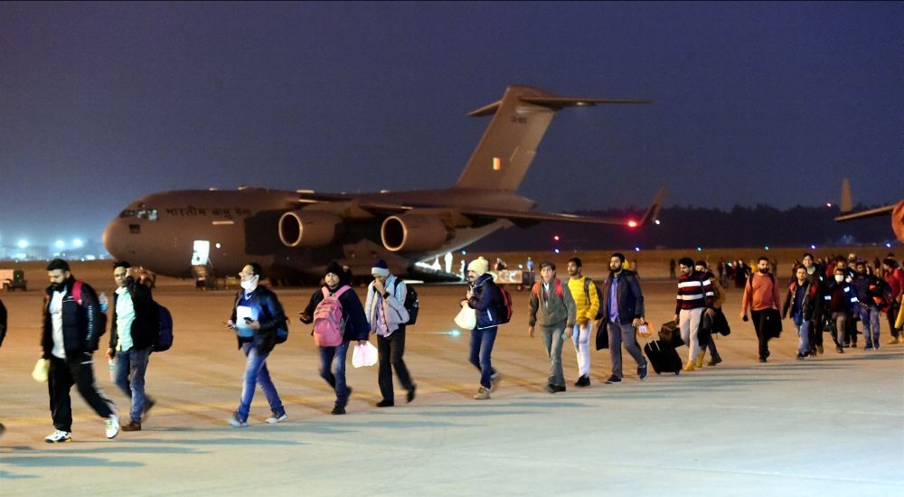 Ghaziabad: Indian nationals walk after deboarding from an IAF plane with evacuated people from war hit Ukraine, upon its arrival at Hindan in Ghaziabad, Thursday, March 10, 2022. As part of Operation Ganga, IAF C-17  aircraft carrying 146  passengers, mostly Indian students and 27 foreign nationals returned to Hindan airbase near Delhi, from Bucharest. (PTI Photo/Kamal Kishore)