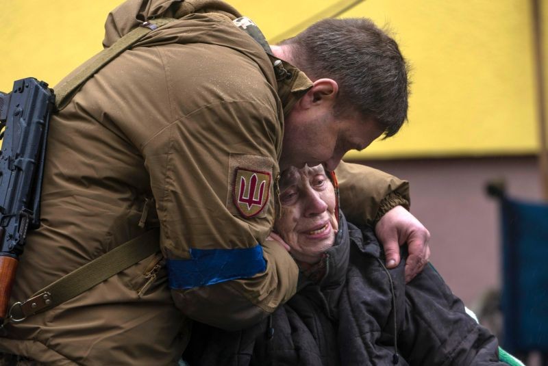 A soldier comforts Larysa Kolesnyk, 82, after she was evacuated from Irpin, on the outskirts of Kyiv, Ukraine on March 30. (AP/PTI Photo)