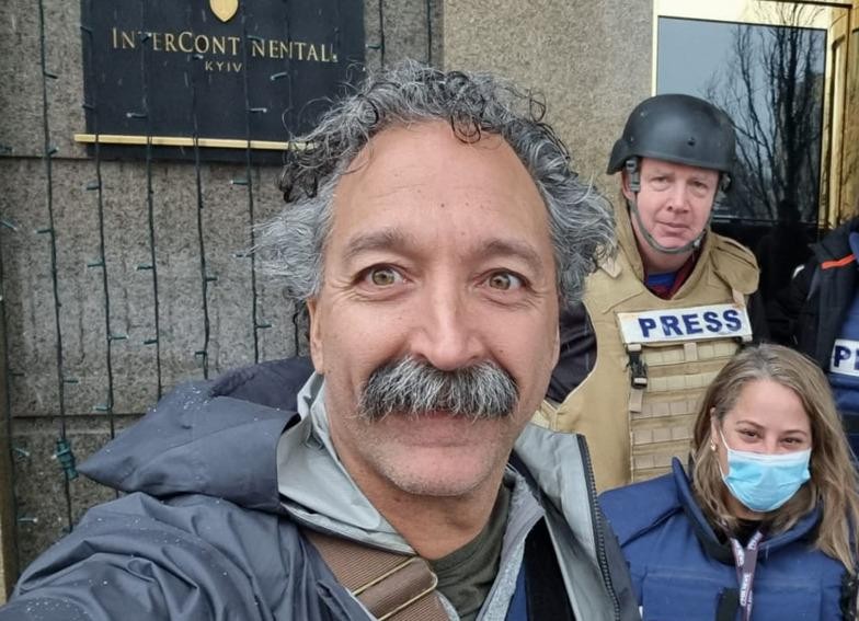 This image released by Fox News Channel shows cameraman Pierre Zakrzewski while on assignment with colleagues, Fox News correspondent Steve Harrigan and Jerusalem-based senior producer Yonat Friling, background right, in Kyiv. Zakrzewski was killed in Ukraine on Monday, March 14, 2022, when the vehicle he was traveling in was struck by incoming fire. Zakrzewski was a veteran war photographer who had covered conflicts in Iraq, Afghanistan and Syria for Fox. (AP Photo)