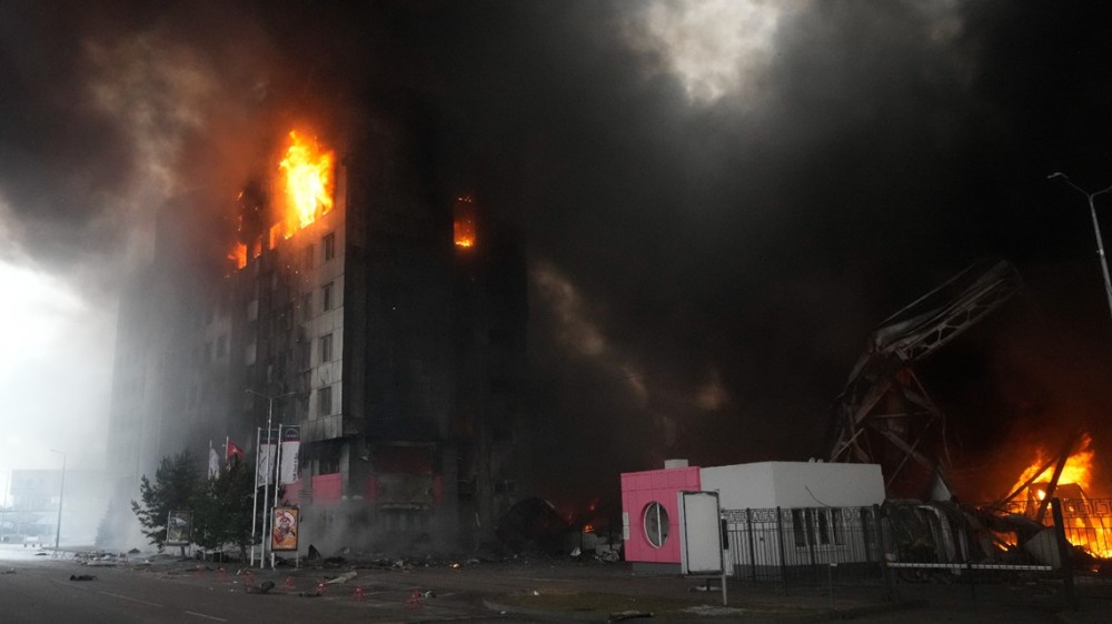 A building burns after shelling in Kyiv, Ukraine, Thursday, March 3, 2022. Russia has launched a wide-ranging attack on Ukraine, hitting cities and bases with airstrikes or shelling. (AP Photo/Efrem Lukatsky)