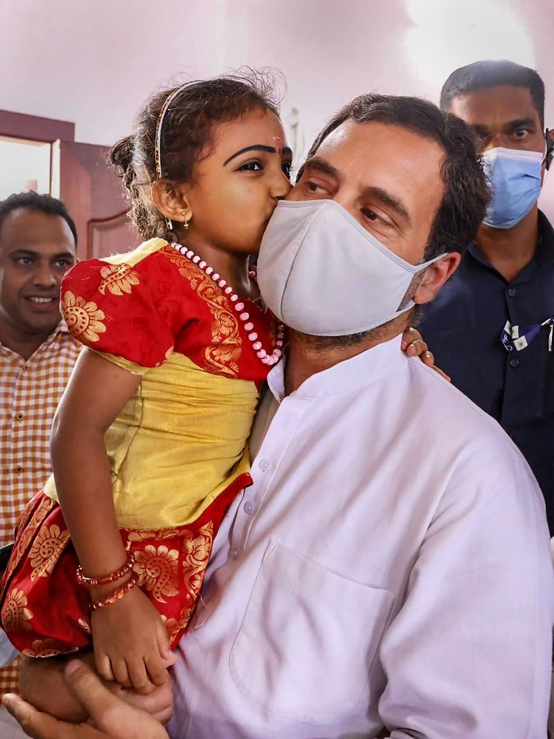ongress leader Rahul Gandhi with a child, during the inauguration of an ancillary building at Thariyode Gram Panchayath, in Kalpetta on March 8, 2022. (PTI Photo)