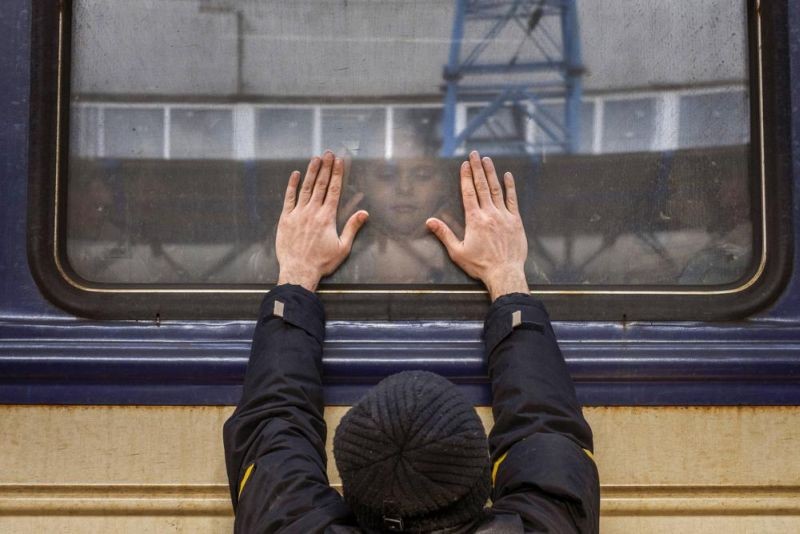 Aleksander, 41, presses his palms against the window as he says goodbye to his daughter Anna, 5, on a train to Lviv at the Kyiv station, Ukraine on March 4. 2022. Aleksander has to stay behind to fight in the war while his family leaves the country to seek refuge in a neighboring country. (AP Photo)
