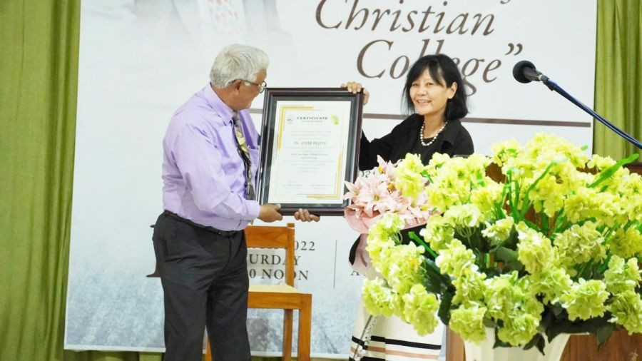 Dr Vivee Peseye receives the first Patkai Christian College (Autonomous) Annual Alumni Excellence Award from Rev Dr Tuisem A Shishak, the college founder and Principal Emeritus, on March 19. (Photo Courtesy: DMMC Patkai)
