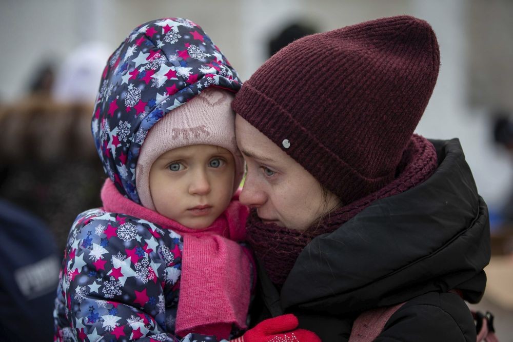 Medyka: A mother and her child, fleeing Ukraine, wait to board a bus at the border crossing in Medyka, Poland, Poland, Tuesday, March 8, 2022. Russia's invasion of Ukraine has set off the largest mass migration in Europe in decades, with more than 1.5 million people having crossed from Ukraine into neighboring countries.AP/PTI