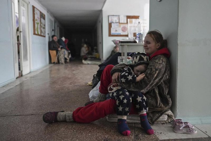 Anastasia Erashova cries as she hugs her child in a corridor of a hospital in Mariupol, Ukraine on Friday, March 11, 2022. Anastasia's other child was killed during shelling in Mariupol. (AP Photo)