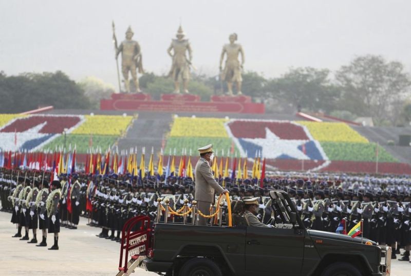 Senior Gen. Min Aung Hlaing, head of the military council, inspects officers during a parade to commemorate Myanmar's 77th Armed Forces Day in Naypyitaw, Myanmar, Sunday, March 27, 2022. The occasion commemorates resistance against Japanese occupiers during World War II, and is a show of strength as the military battles armed resistance to its takeover last year that ousted the elected government of Aung San Suu Kyi. (AP Photo)