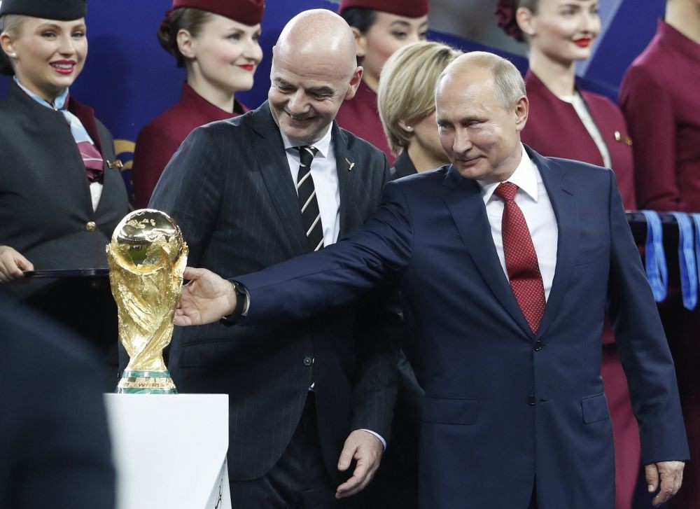 Moscow: FILE - Russian President Vladimir Putin touches the World Cup trophy as FIFA President Gianni Infantino stands beside him, at the end of the final match between France and Croatia at the 2018 soccer World Cup in the Luzhniki Stadium in Moscow, Russia, Sunday, July 15, 2018. In a sweeping move to isolate and condemn Russia after invading Ukraine, the International Olympic Committee urged sports bodies on Monday to exclude the country's athletes and officials from international events. The decision opened the way for FIFA, the governing body of soccer, to exclude Russia from a World Cup qualifying playoff match on March 24. Poland has refused to play the scheduled game against Russia. AP/PTI