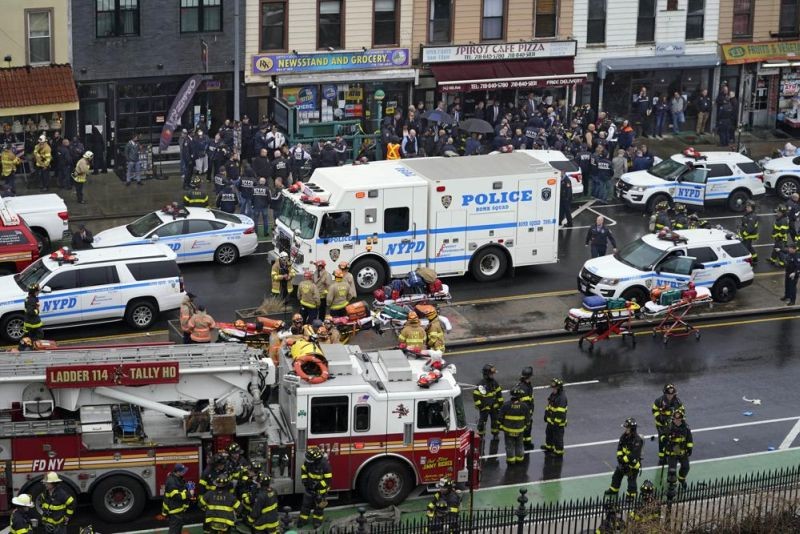 Emergency personnel gather at the entrance to a subway stop in the Brooklyn borough of New York, Tuesday, April 12, 2022. Multiple people were shot and injured Tuesday at a subway station in New York City during a morning rush hour attack that left wounded commuters bleeding on a train platform. (AP Photo)