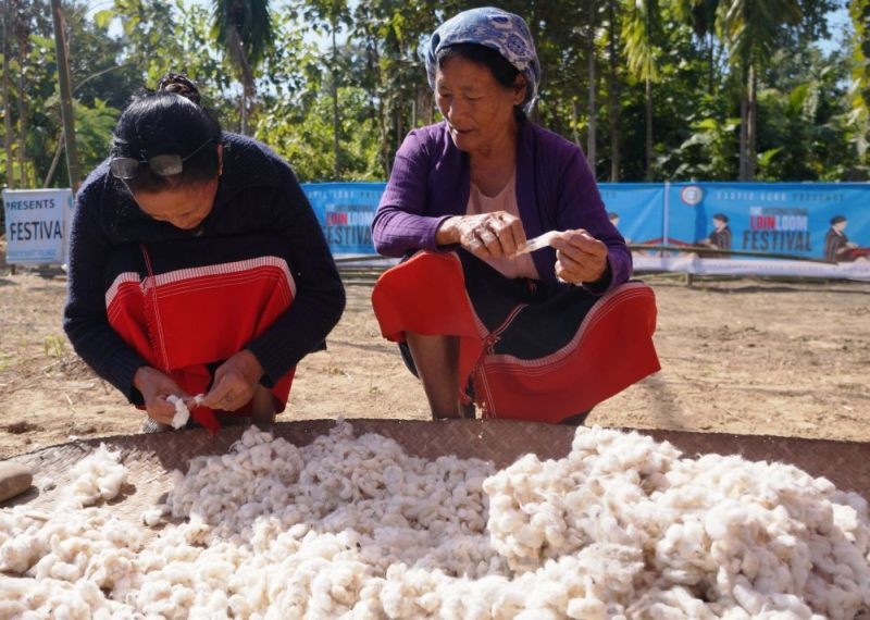 Two elderly women clean raw cotton to demonstrate the traditional method of making yarn to be used for weaving at the 6th edition of the International Loinloom Festival 2019 at Diezephe Craft Village, 10 km away from Dimapur on December 6, 2019. (Morung File Photo)