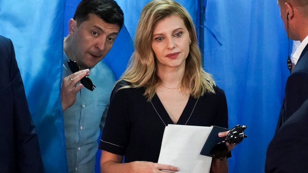 FILE - Ukrainian President Volodymyr Zelenskyy, left, and his wife Olena Zelenska leave a booth at a polling station during a parliamentary election in Kiev, Ukraine, Sunday, July 21, 2019 (AP Photo File)