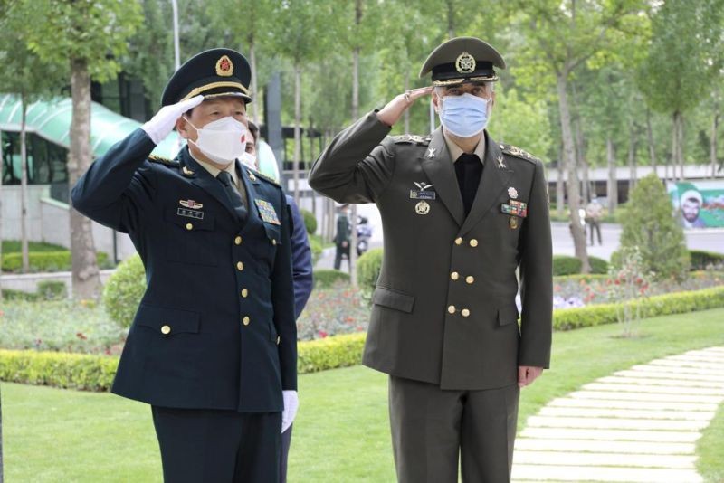 In this picture released by the official website of the Iranian Defense Ministry, China's minister of national defense Gen. Wei Fenghe, left, is welcomed by Iran's defense minister Gen. Mohammad Reza Ashtiani, during an official welcoming ceremony, in Tehran, Iran, Wednesday, April 27, 2022. (AP Photo)