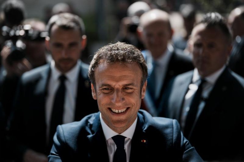 French President and centrist candidate Emmanuel Macron greets well-wishers after casting his vote in Le Touquet, northern France, Sunday, April 24, 2022. France began voting in a presidential runoff election Sunday with repercussions for Europe's future, with centrist incumbent Emmanuel Macron the front-runner but fighting a tough challenge from far-right contender Marine Le Pen. (AP Photo)
